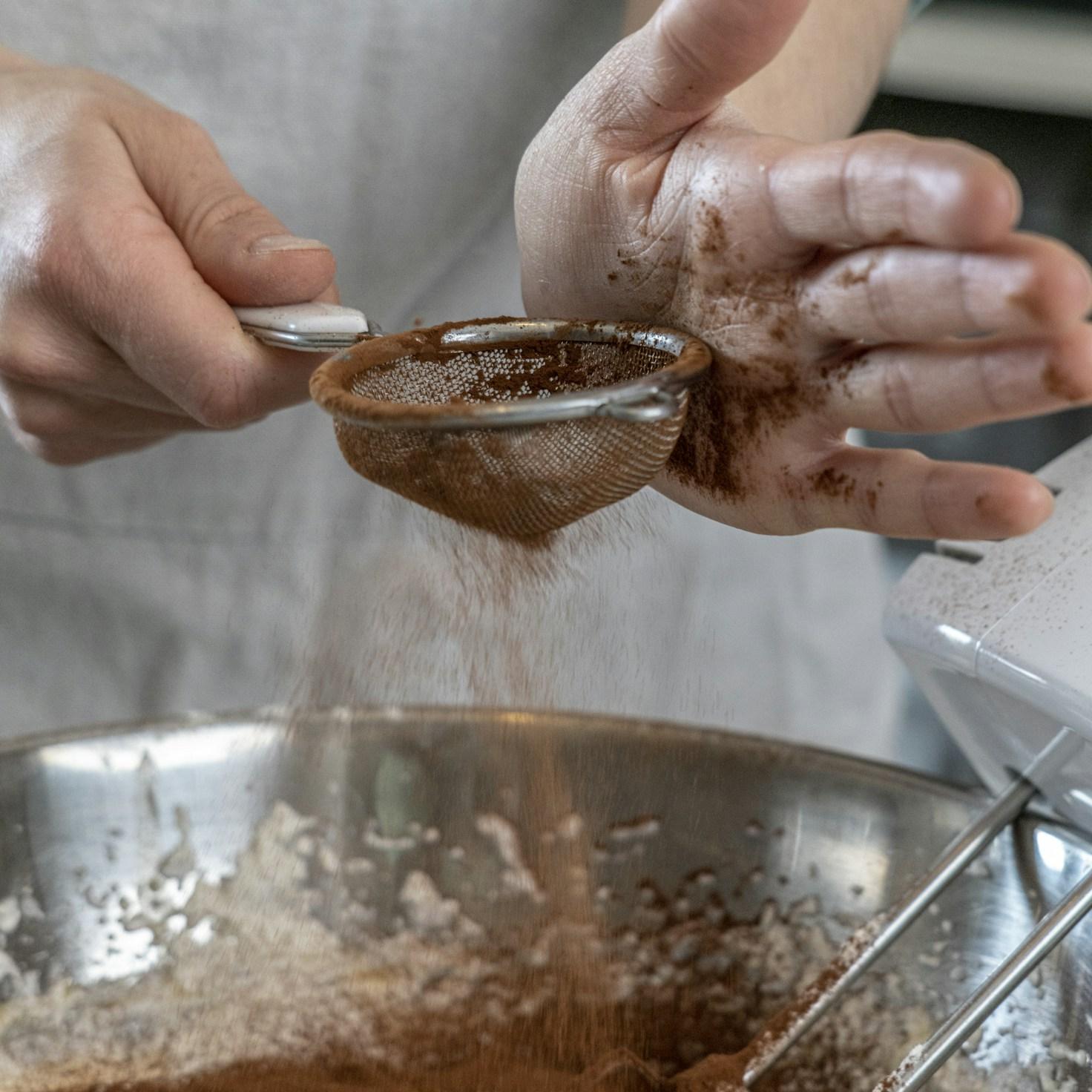 Community members collaborating in a modern kitchen space, sharing recipes and cooking techniques